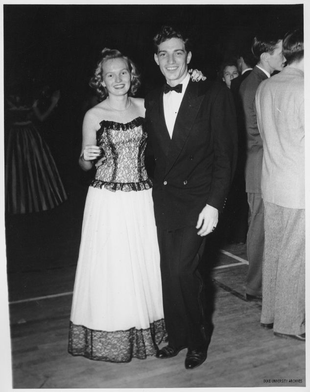 1940s vintage dance image, featuring a young couple. The young woman is wearing a beautiful 1940s evening gown and the young man a tux. 