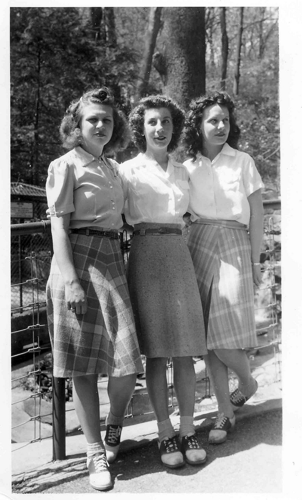 1940s teen girls in wool plaid skirts and saddle shoes. Super 1940s fashions and 1940s hairstyles. 