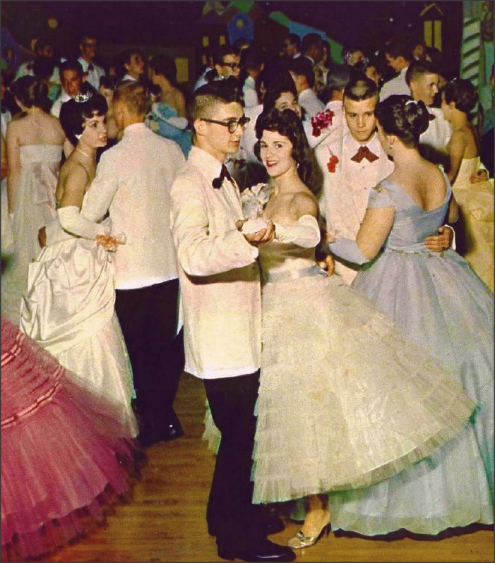 1950s vintage photo of a prom dance / 1950s formal dance featuring 1950s prom dresses and 1950s hairstyles. 