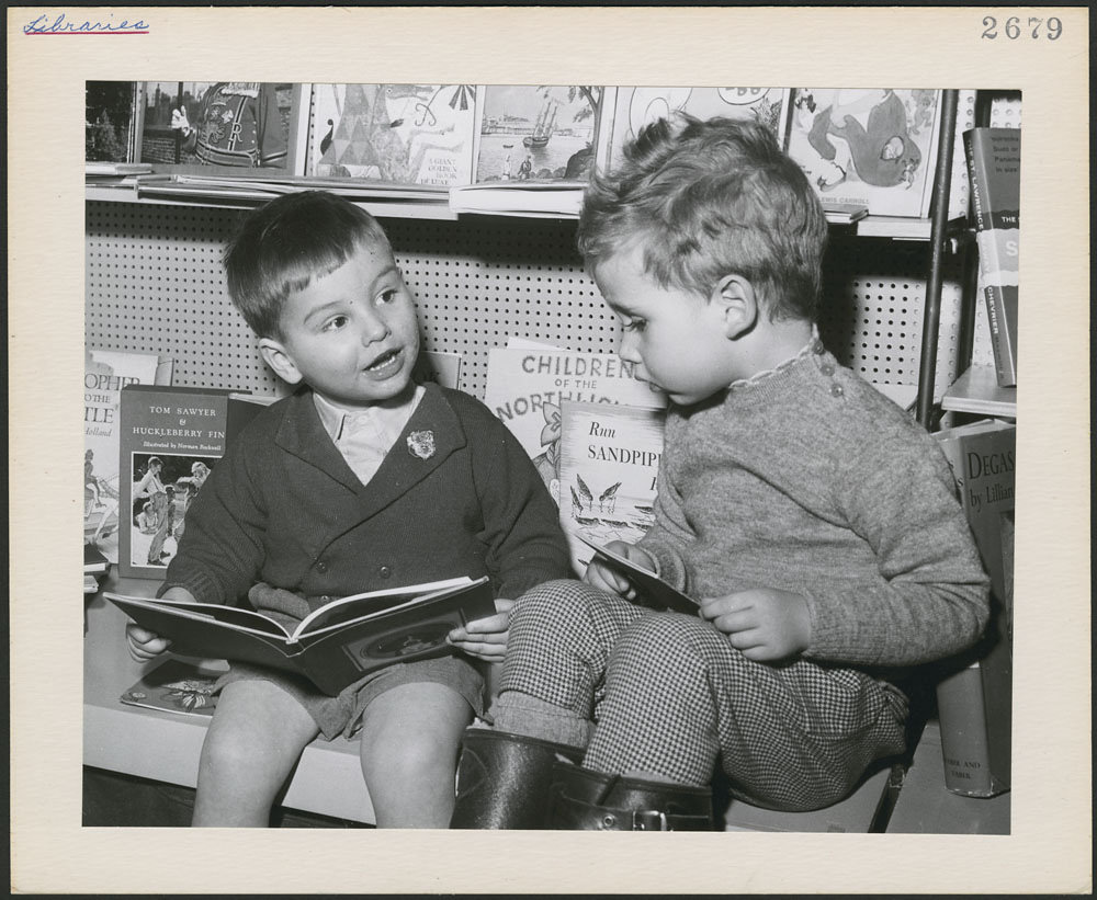 1940s vintage photo of Two young boys, seated with books, in the children's department of a Toronto public library, Toronto, Ontario 