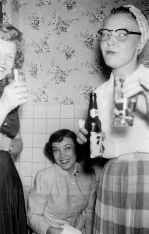 1950s vintage women having a party together in 1950s hairstyles and 1950s fashions. 