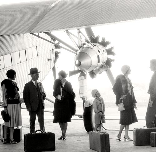 Early 1930s air travel as seen in a late 1920s early 1930s vintage photo of people in stylish 1920s/ 1930s fashions.