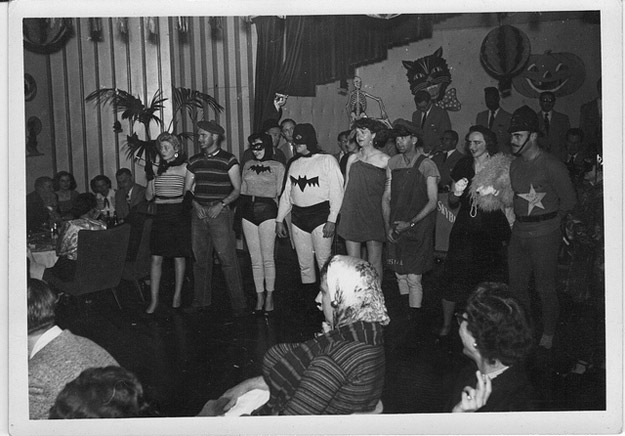 1950s halloween vintage image of a halloween party featuring batman and batgirl 