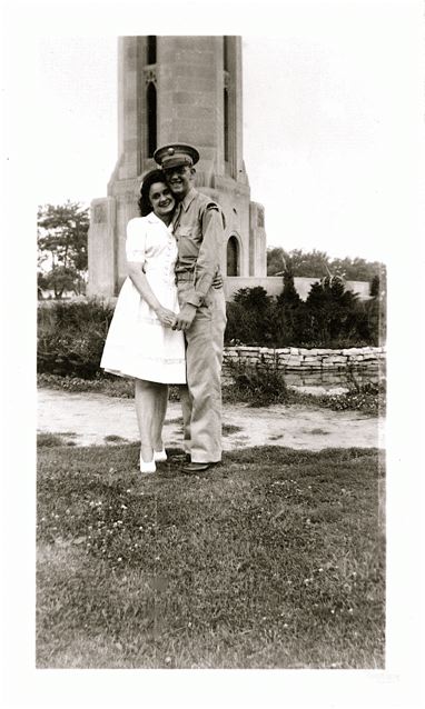 1940s vintage photo of a man and woman posing together for a photo during WW2. They are Gene and Mickey at the Carillon Tower on Belle Isle in Detroit during WWII