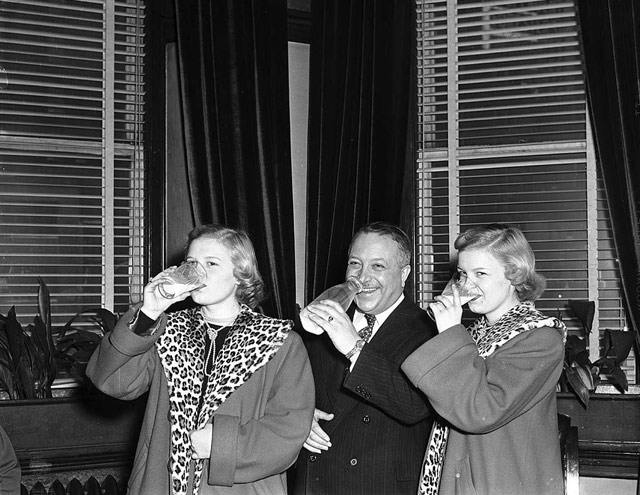 1950s vintage photo: Toronto Mayor Hiram E. McCallum and Ice Follies performers drink milk at civic reception, Old City Hall. LOVE those leopard print jackets!