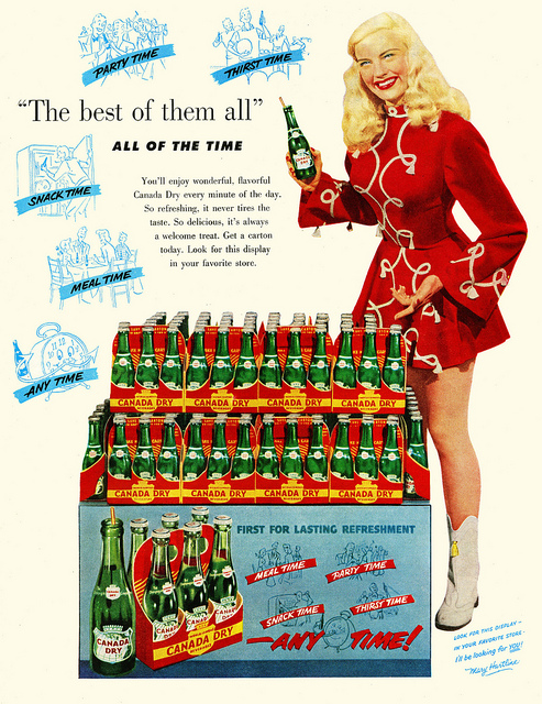 1950s vintage ad for a 1951 Canada Dry Ginger Ale featuring Mary Hartline in a band uniform and 1950s hairstyle. 