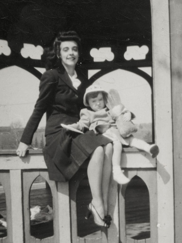 1940s vintage photo of a mom with her daughter posing for a photo. Pretty 1940s fashions and 1940s Hairstyle