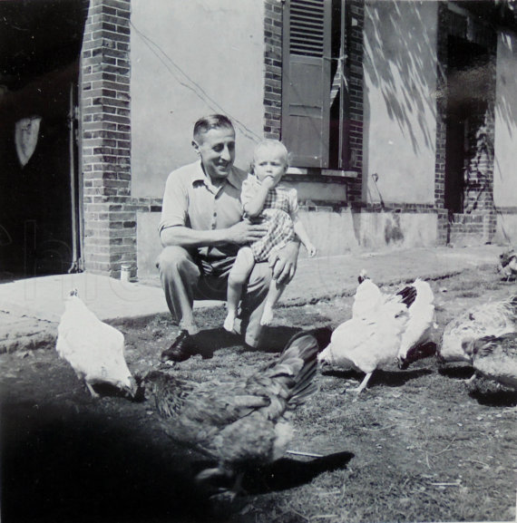 1940s vintage photo of father with kids and chickens.