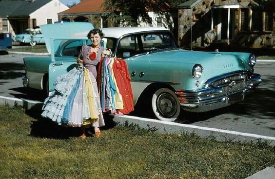 1950s woman in front of 50s car with 1950s dresses. Fun 1950s vintage photo. 