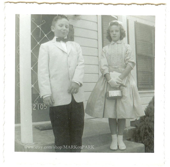 1960s vintage photo of 2 kids dressed up to to an event. 