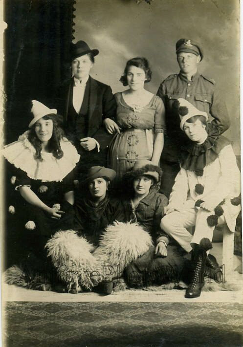 1920s vintage photo of people dressed up for a Halloween party or costume party featuring Harlequin Clowns costumes. 