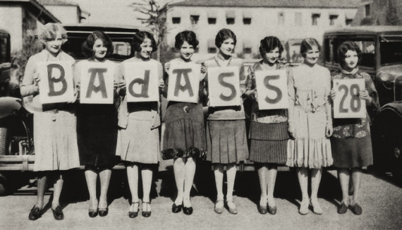 1920s vintage photo of sorority sisters holding signs in 1920s fashions that say "Bas Ass 1928"