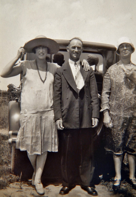 1920s Vintage Photo of a young woman in 1920s Fashions with her parents also dress like 1920s Flappers. Standing in front of their car. 