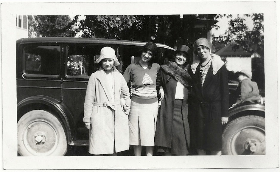 1920s Vintage Photo of 4 women in 1920s Fashions (1920s coats, 1920s hats, 1920s skirt & top) in front of their 1920s car. 