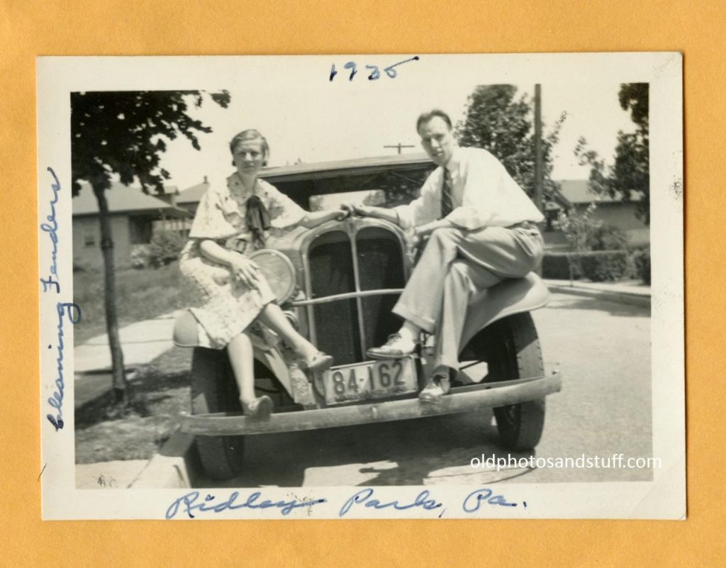 1930s Vintage Photo of a couple posing on their car in 1930s fashions-1935. 