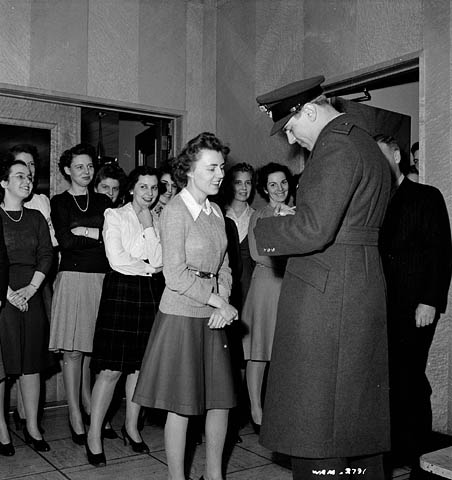 1940s Vintage Photo: 1943-Women of the Aluminum Co. wait in line to get an autograph from famous Canadian fighter pilot 'George "Buzz" Beurling'. Helen Fowler is the lucky lady first in line.