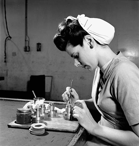 1940s vintage photo: ww2 canadian woman working for the war effort - Female worker Margot Bourassa shellacs the body of a fuse in the breakdown room of the Cherrier plant (Montreal) of the Defense Industries Limited. 