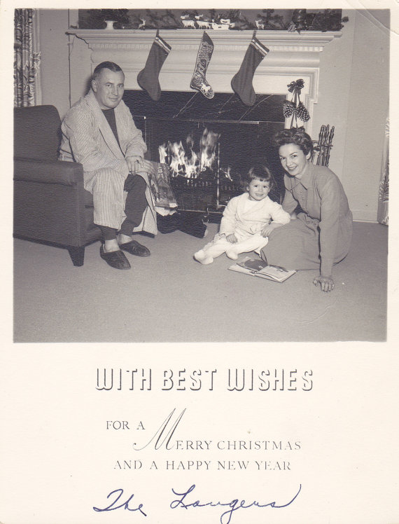 1940s vintage image of family by fireplace posing for their Christmas Card. 