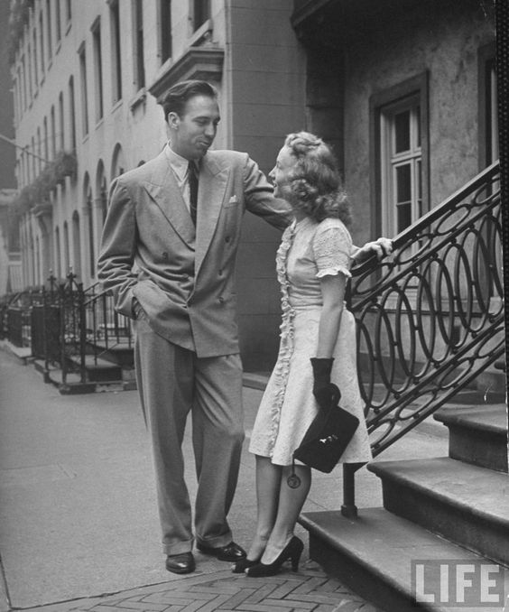 1940s vintage image of man and woman talking in 1940s fashions and 1940s hairstyles as seen in life magazine