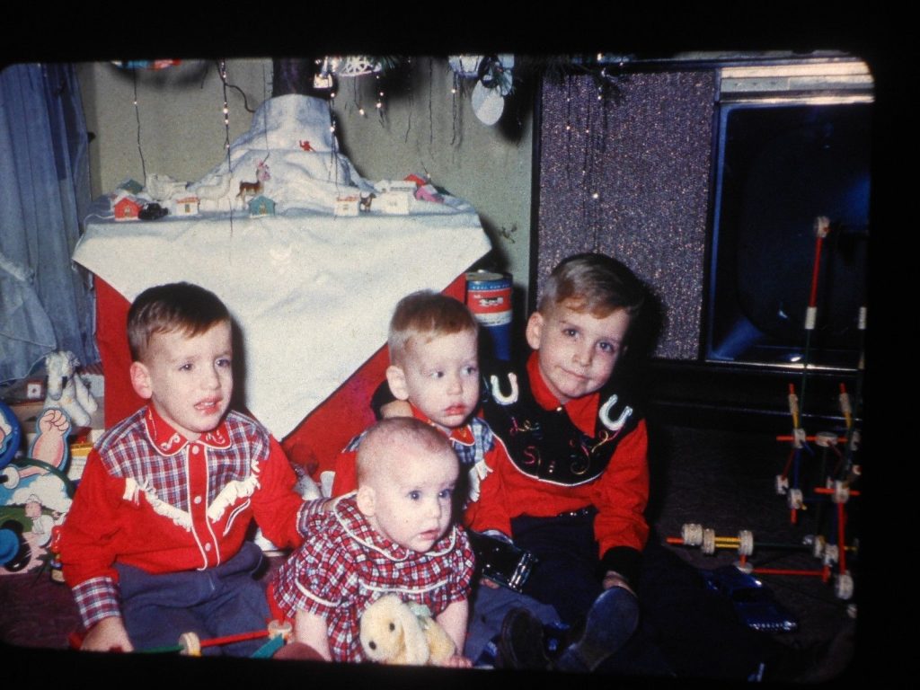 1950's kids in matching cowboy outfits at christmas. 1950s vintage image