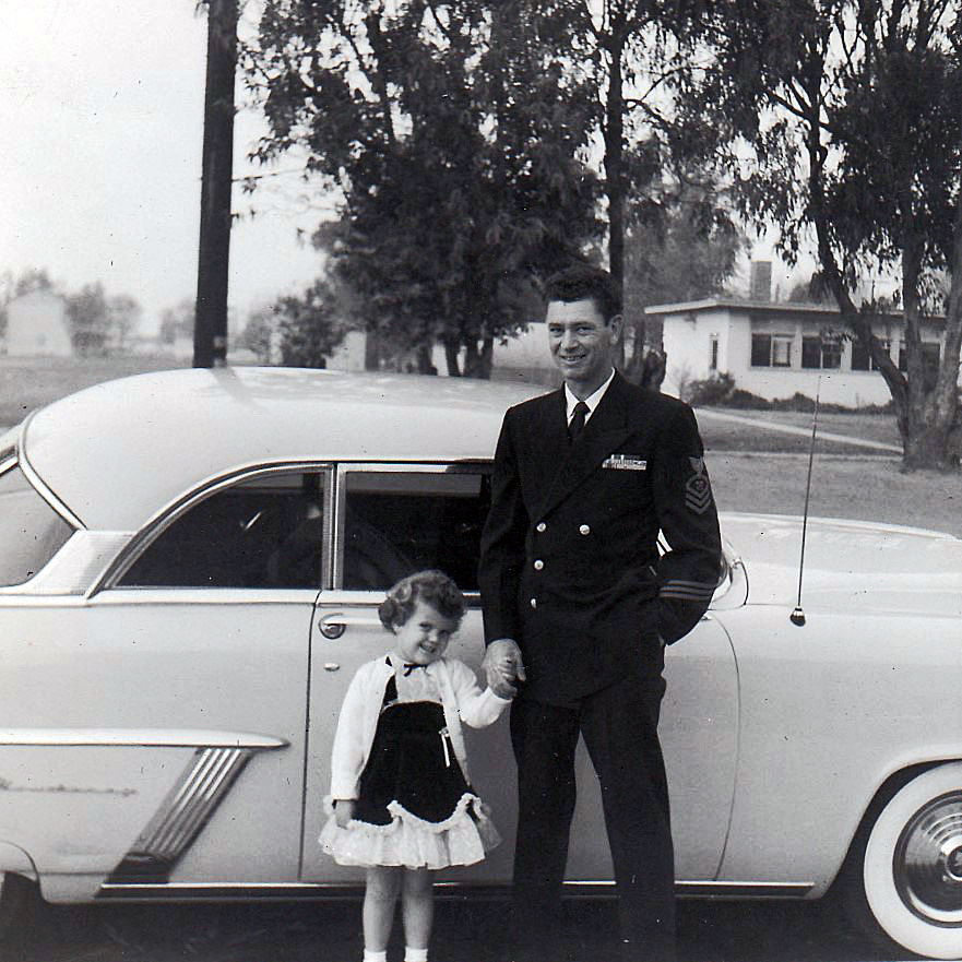 1950's little girl with dad in front of vintage car. 1950s vintage image