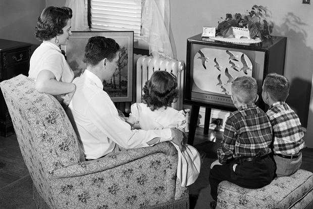 1950s vintage image of a family watching tv