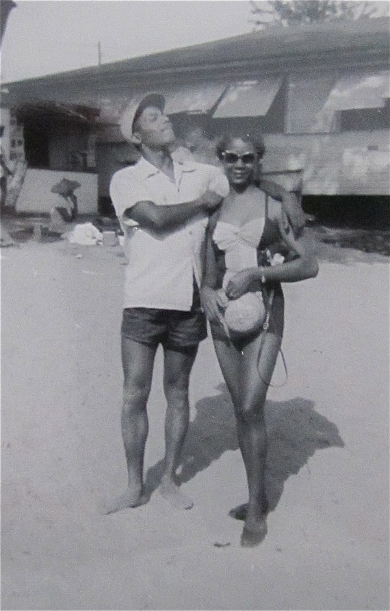 1950's vintage image of  a Black couple at the beach in 1950s swimsuits