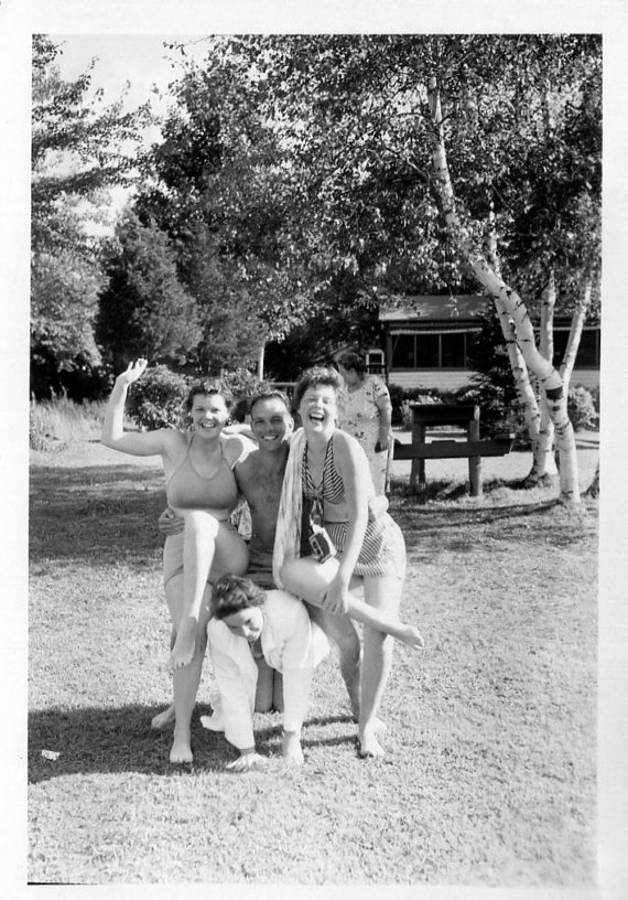 1950s vintage image of friends in the summer having fun together in 1950s summer fashions. 