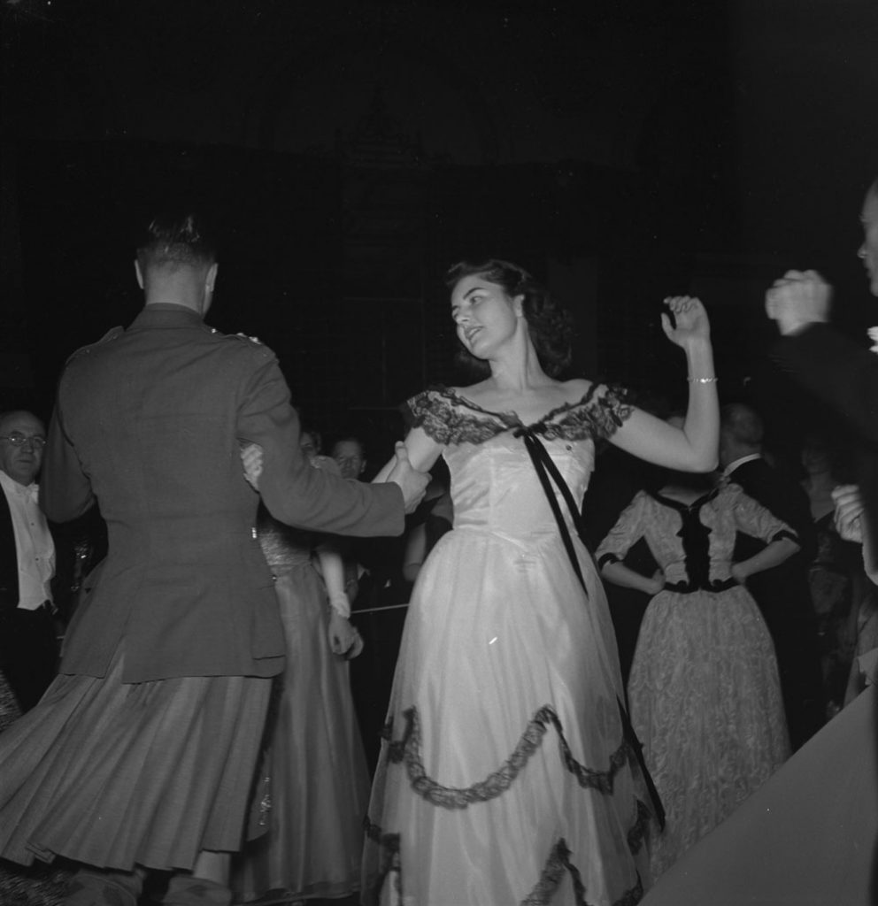 1940's Canadian Highland Regiment soldier and beautiful woman share a dance together.