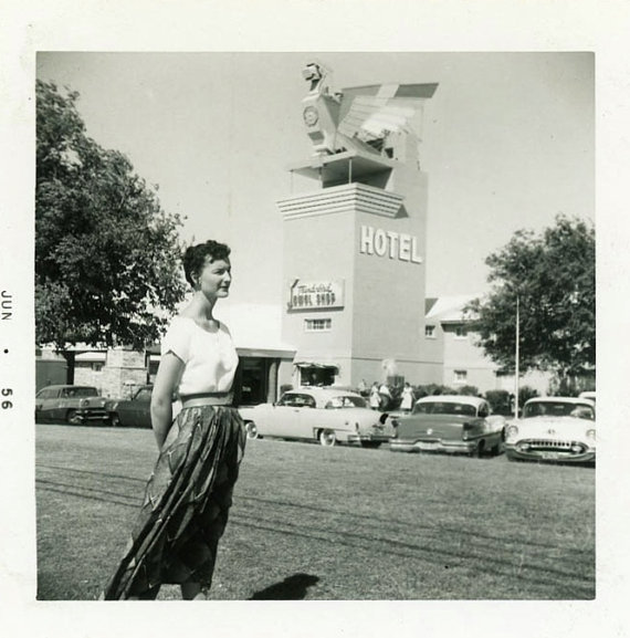 1950s vintage image of woman in front of a hotel