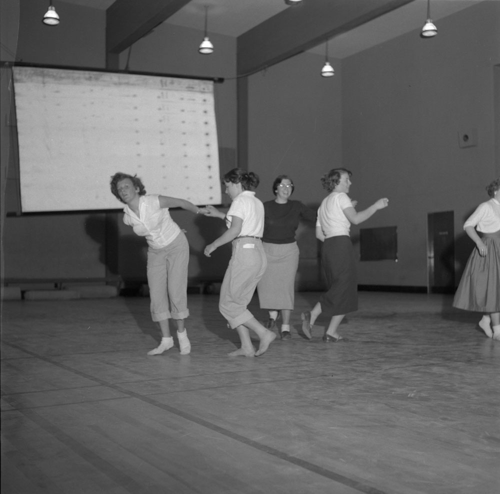 1950's vintage image of women dancing at a social dance in 1950s fashions