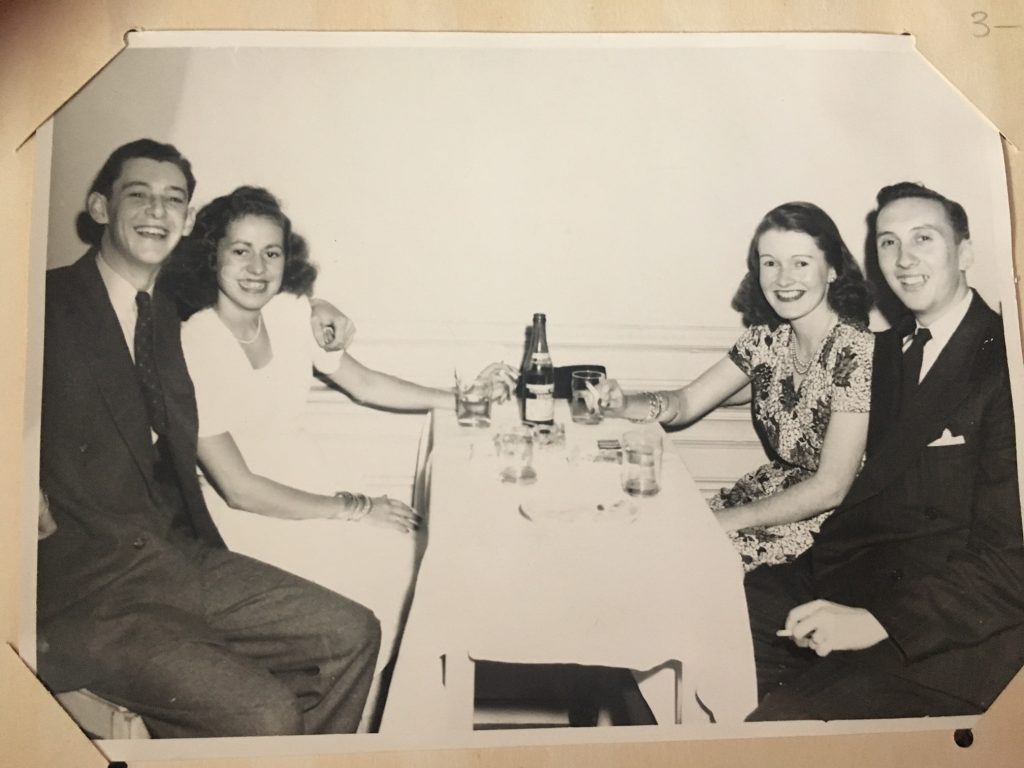 Date night - 1940's photo taken at King Edward Hotel Toronto of two young couples drinking and smoking together in 1940s fashions. 