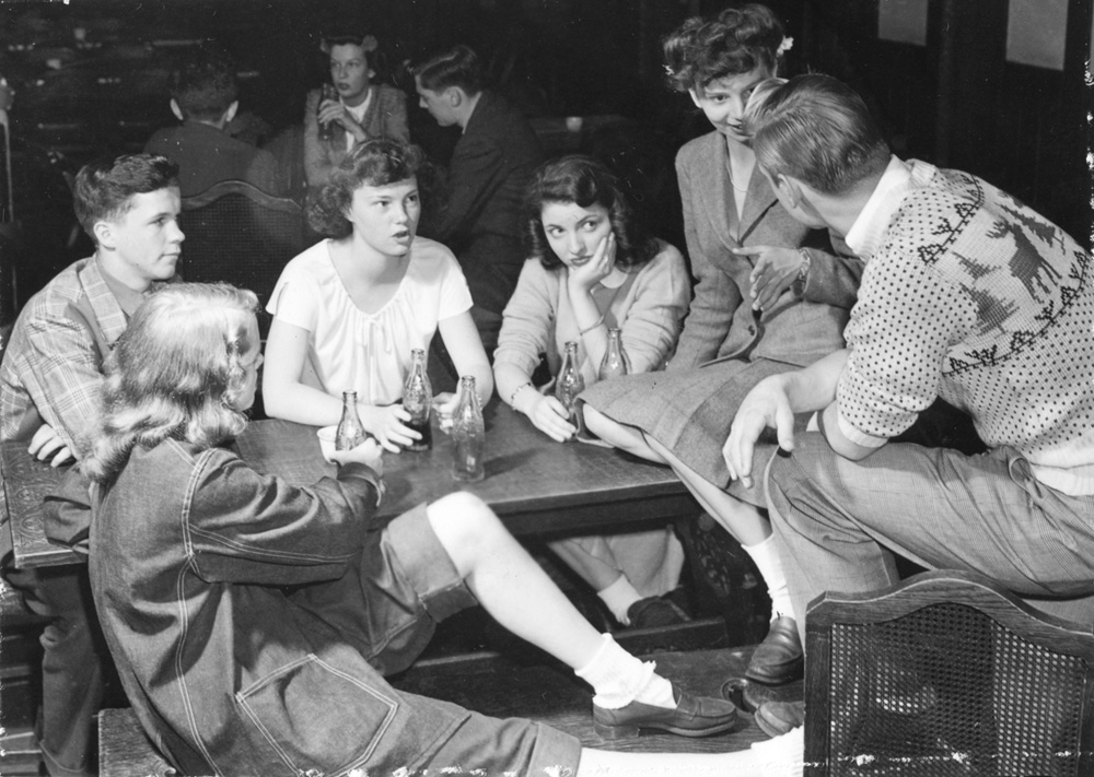 Hanging out in the dining hall with friends and cokes-1940's vintage image of student life at the University of Chicago.