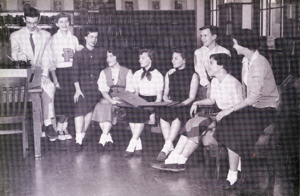 1954 Record Club at the University of Nashville vintage image.1950s fashions like saddle shoes, pencil skirts, scarfs around the neck and even a cheerleading uniform are on display. 