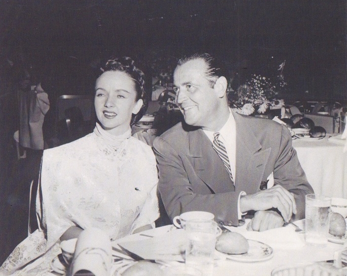 1940s vintage photo of swing dancers Jean Veloz and Frank Veloz sitting together at dinner. 