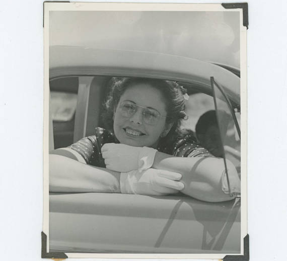 1940s / 1950s vintage image of woman in a car wearing glasses