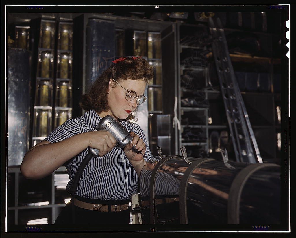 1940s vintage image of a woman working in a plant during the war