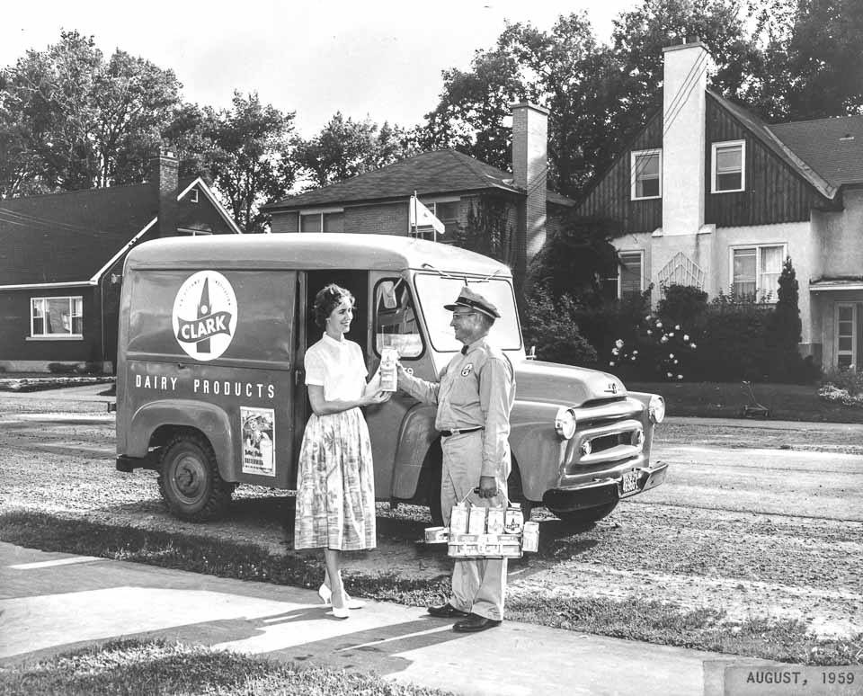 1950s Vintage Photo of Clark's Dairy milk delivery in Ottawa - Aug. 1959 featuring a woman in 1950s fashions and the milkman on his delivery.