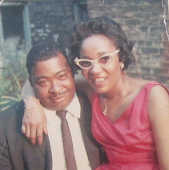 Original 1960's Young Black couple posing in their 1960s clothing for the photo. 