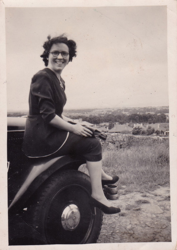 Smiling Young Lady Sitting On Car - Vintage 1940s Snapshot Photo