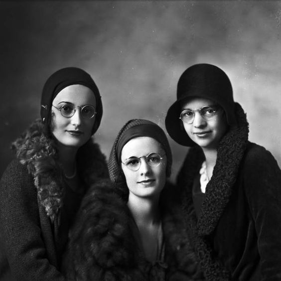 pretty 1930s woman in eyeglasses and amazing late 1920s coats and late 1920s hats / early 1930s. 