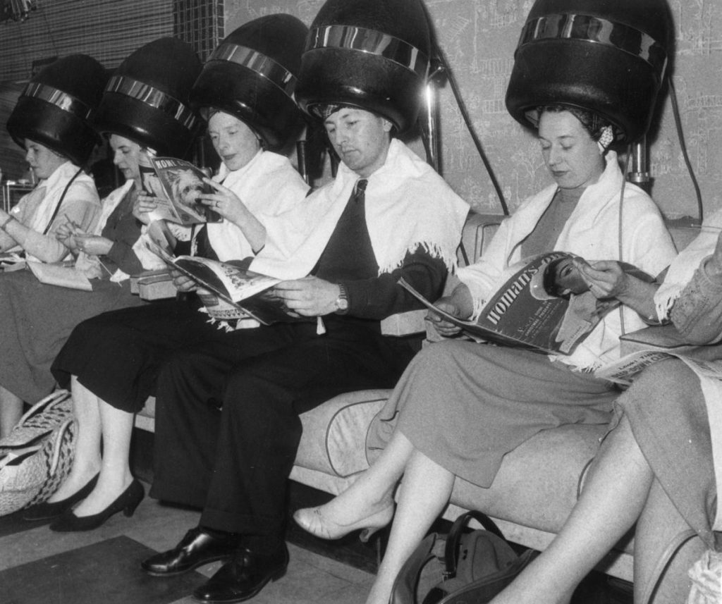 vintage hair salon with woman and men - getty images