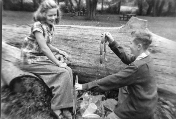 vintage 1950s photo of a boy and girl with hot dogs having a picnic