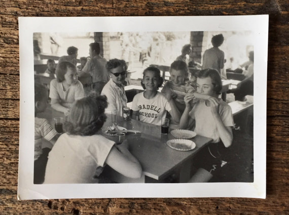 1950s vintage photo of kids eating at a table at camp in 1957. 