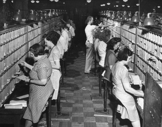 1944 Vintage photo of women working in a post office sorting mail. 