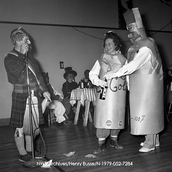 1950s vintage photo of a 1954 halloween costume contest featuring 2 adults dressed as pop bottles