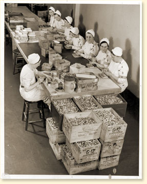 1940s canadian women on the homefront producing primers in a factory for the WW2 Canadian Home Front Effort.