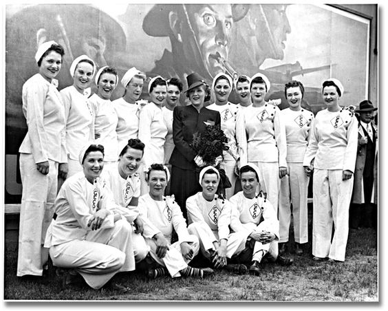 1940s Vintage Photo of Actress Mary Pickford posing with a group of employees during her visit to the General Engineering Company (Canada) munitions factory, June 5, 1943.