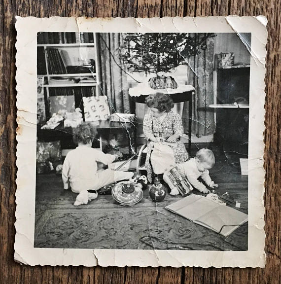 vintage photo of kids opening gifts on christmas morning 1940s 1950s