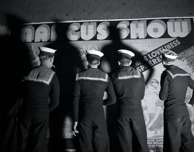 1940s vintage photo of four sailors standing in front of a sign for the Marcus Dance Show in Halifax, Nova Scotia during WW2. 